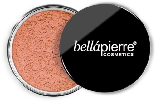 A round container of peach-colored loose powder with a black lid labeled 'bellápierre cosmetics'.