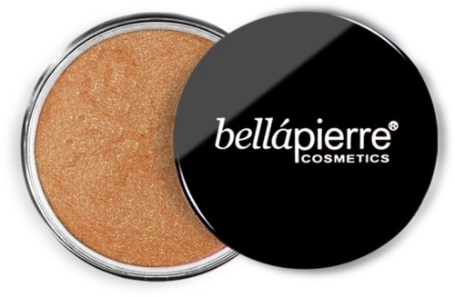 A small round container of beige makeup with a black lid that has white text saying 'bellápierre COSMETICS'.