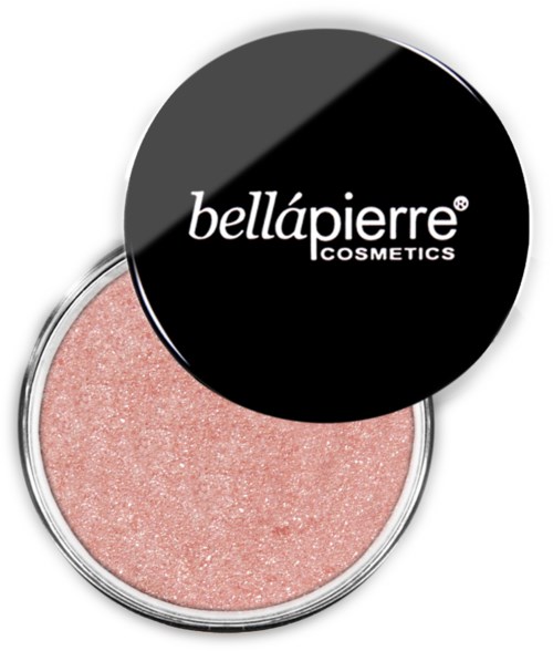 A round blush Compact with a black lid displaying white text, revealing a pink shimmering blush inside.