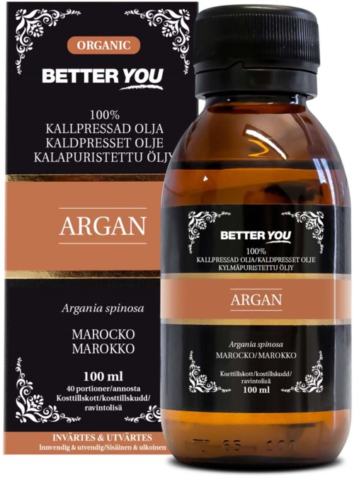 En liten brun flaska med arganolja och svart lock, bredvid sin svarta och orange etikett. Etiketten säger 'Better You', 'Argan' och '100ml'.