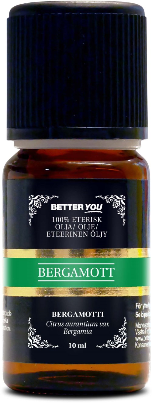 Pieni kellertävän lasipullon bergamottiuutteella, musta kansi ja vihreä, musta ja kultainen etiketti.