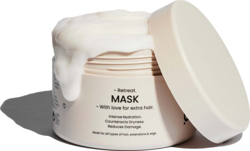 A hair mask jar with white cream overflowing, text describing its benefits for hair nourishment and repair.