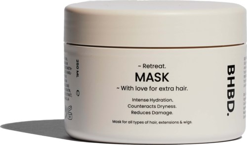 A white jar labeled as a hair mask that provides hydration and reduces damage for all hair types.