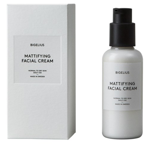 En vit flaska med ansiktskräm med svart lock bredvid en vit box, båda märkta "Bigelius Mattifying Facial Cream."