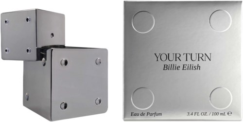 Een parfumfles met een simpel, modern zilveren ontwerp en een bijpassend zilveren doos met Billie Eilish.