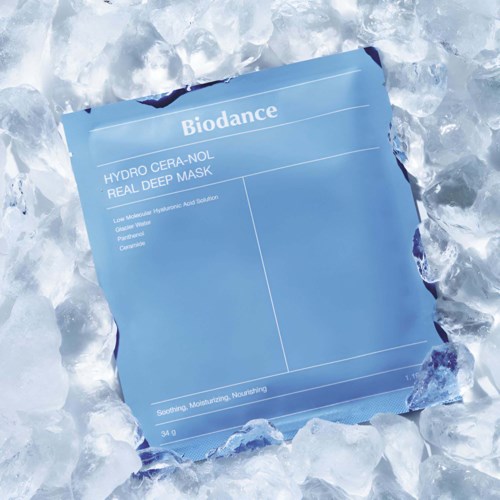 Blue skincare face mask package with the brand name Biodance, surrounded by ice. The mask is for intensive hydration and nourishment.