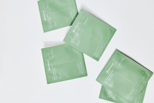 Four green tennis court tickets are laid out on a white surface.