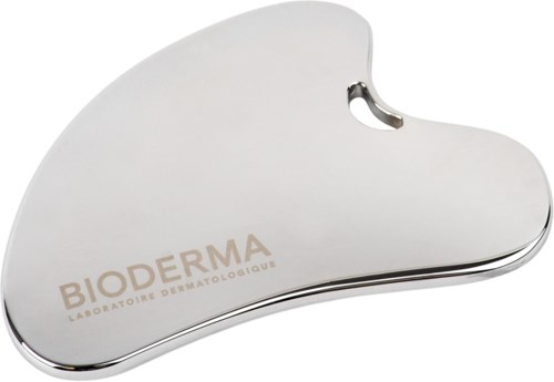 A white, kidney-shaped skincare spatula with a small cutout, branded 'BIODERMA' on the surface.