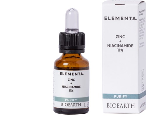 Kleine bruine glazen fles met pipet en doos, gelabeld met zink en niacinamide, bevordert huidreiniging.