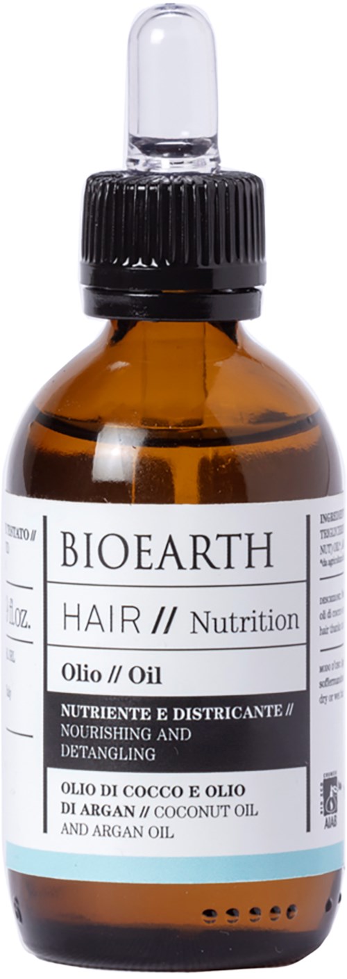 Een bruin glazen fles met een zwarte dop en druppelaar, gemarkeerd BIO EARTH, haarvoedende olie met kokos- en arganolie.