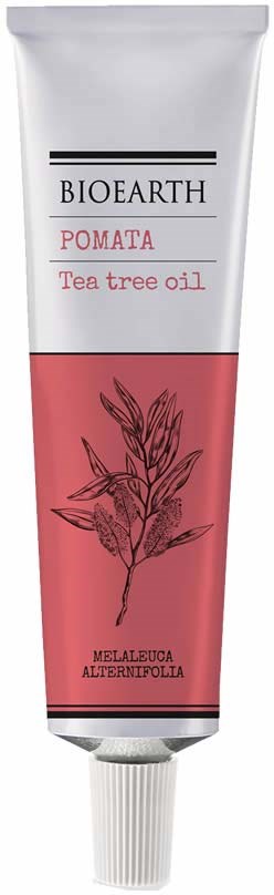 Een tube Bioearth-pomade met tea tree olie, met een roze label en een eenvoudige bladillustratie.