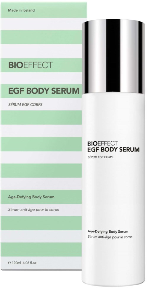 A white bottle with silver cap next to green and white striped packaging for bioactive EGF body serum.