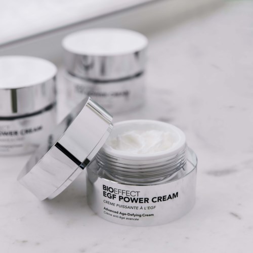 Open jar of BIOEFFECT EGF Power Cream on a white surface. Two more closed jars are in the background.