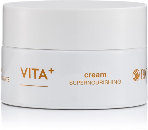 A white jar labeled VITA+ cream, designed for nourishing skin. It has a simple, clean appearance. There is text and an icon.