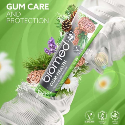 A tube of bioMed gum care toothpaste with green background, surrounded by pine needles, pinecones, and flowers.