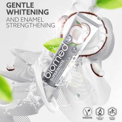 Toothpaste tube labeled 'Olamo Superwhite' with coconut and mint ingredients, surrounded by coconut and mint leaves and splashes.