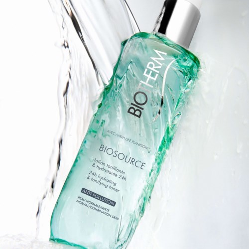 A transparent bottle with greenish liquid, labeled 'BIO THERM BIOSOURCE,' surrounded by splashing water.