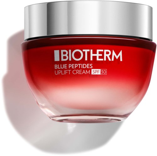 Een rode pot met Biotherm gezichtscrème, zilveren deksel en SPF 30-label.