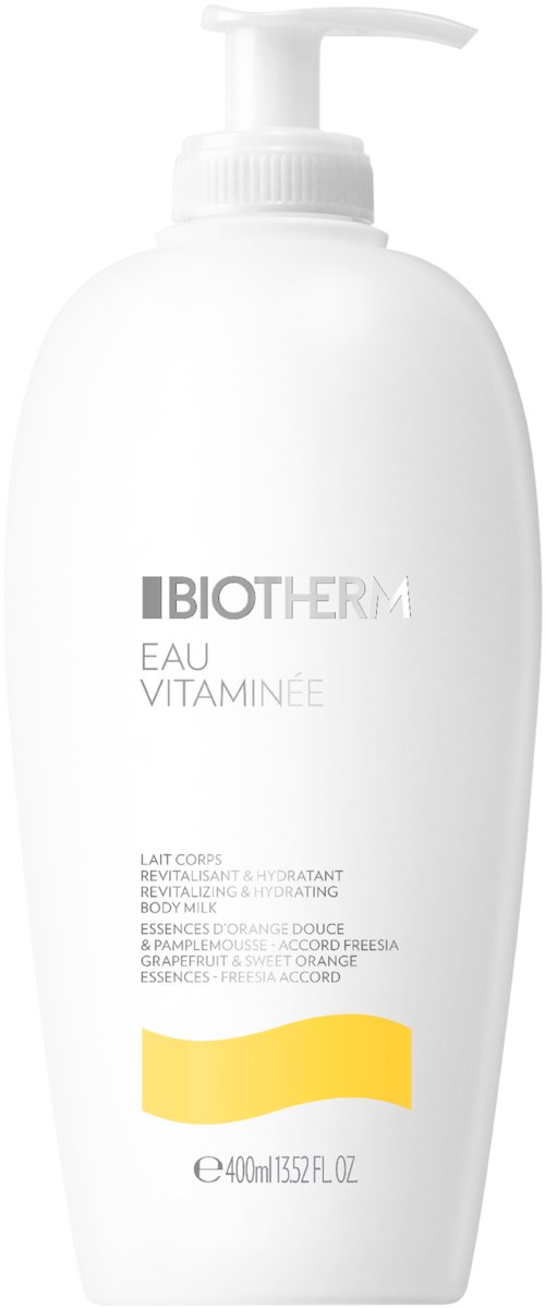 A white bottle with a pump, labeled Biotherm Eau Vitaminee, for revitalizing body milk with orange and grapefruit scent.