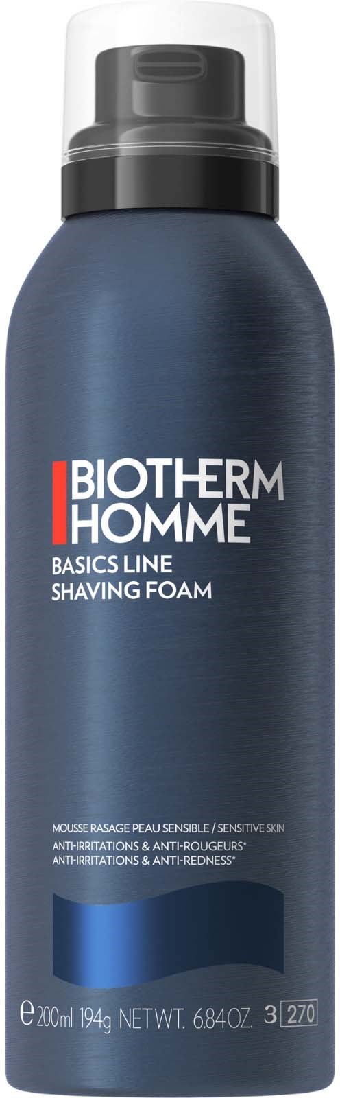A dark blue shaving foam can with a white and black cap, labeled "BIOTHERM HOMME" and "BASICS LINE SHAVING FOAM."