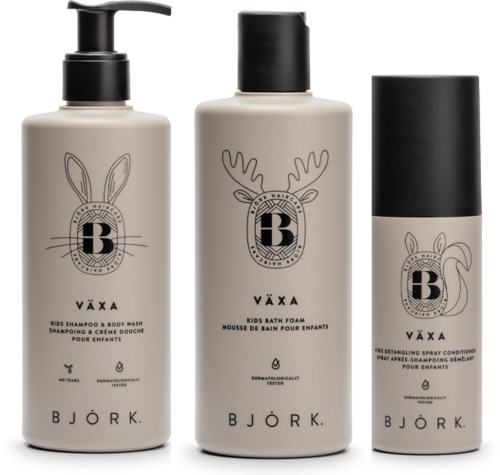 Three baby care products: shampoo, foam, and detangling spray, all in neutral-colored bottles with animal-themed line art and text.