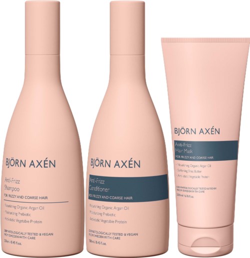 Drie haarverzorgingsproducten in roze flessen en een tube, geschikt voor beschadigd, pluizig en grof haar.