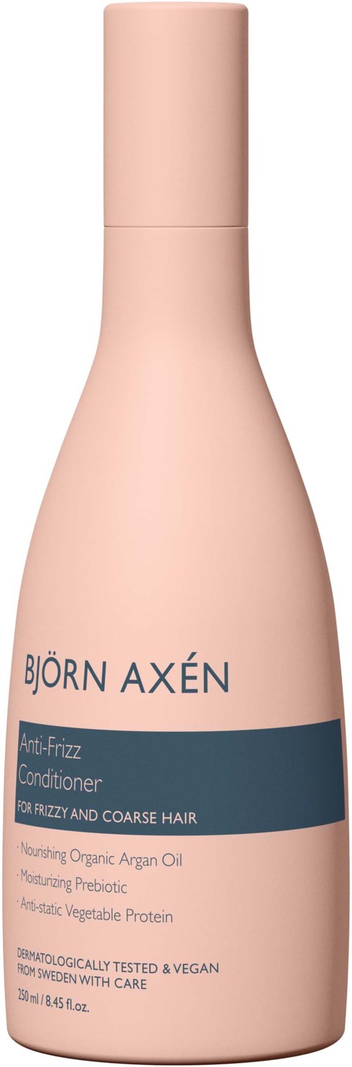 Een lichtroze flesje Björn Axén conditioner voor kroesig, grof haar met biologische ingrediënten en vegan formule.