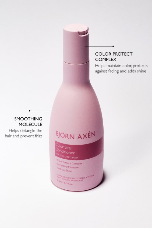 Kleine roze fles met Björn Axén conditioner, gemarkeerd voor kleurbehoud en gladmakende moleculen.