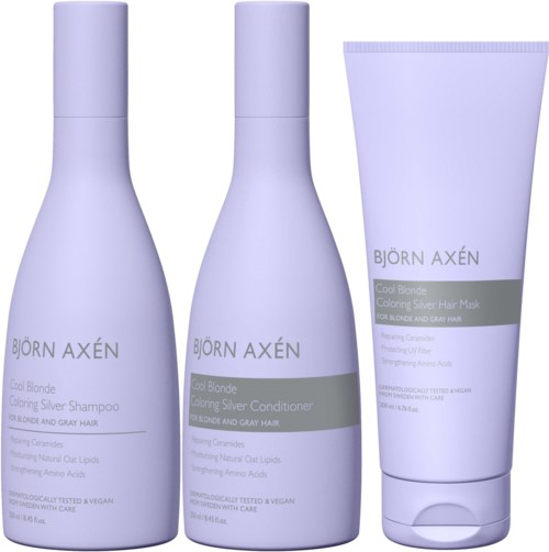 Drie lichtpaarse haarverzorgingsflesjes en een tube met grijze en zwarte labels. Ze zijn voor blond en grijs haar.