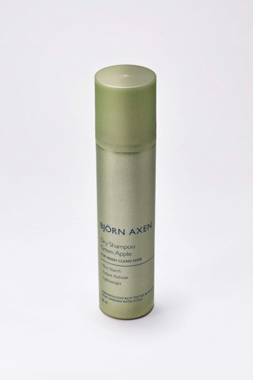 Kleine, lichtgroene sprayfles met label 'Björn Axén' voor haarverzorging.