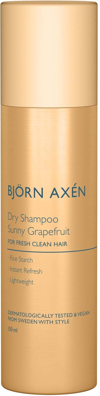 Een gouden flesje Björn Axén droogshampoo met zonnige grapefruitgeur, voor frisse, schone haar.