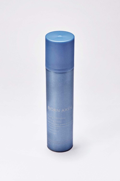 Een blauwe cilindervormige fles met dop, waarschijnlijk een huidverzorgings- of cosmeticaproduct van Born Axel.