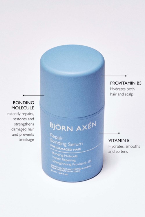 Een blauwe cilindervormige fles met Björn Axén Repair Bonding Serum voor beschadigd haar. Bevat provitamine B5, bonding molecule en vitamine E.