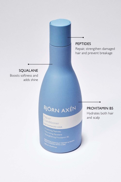 Blauwe haarverzorgingsfles met labels voor peptiden, squalaan en provitamine B5, die hun voordelen voor haar en hoofdhuid beschrijven.