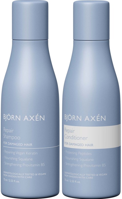 Two light blue bottles labeled as repair shampoo and conditioner for damaged hair.