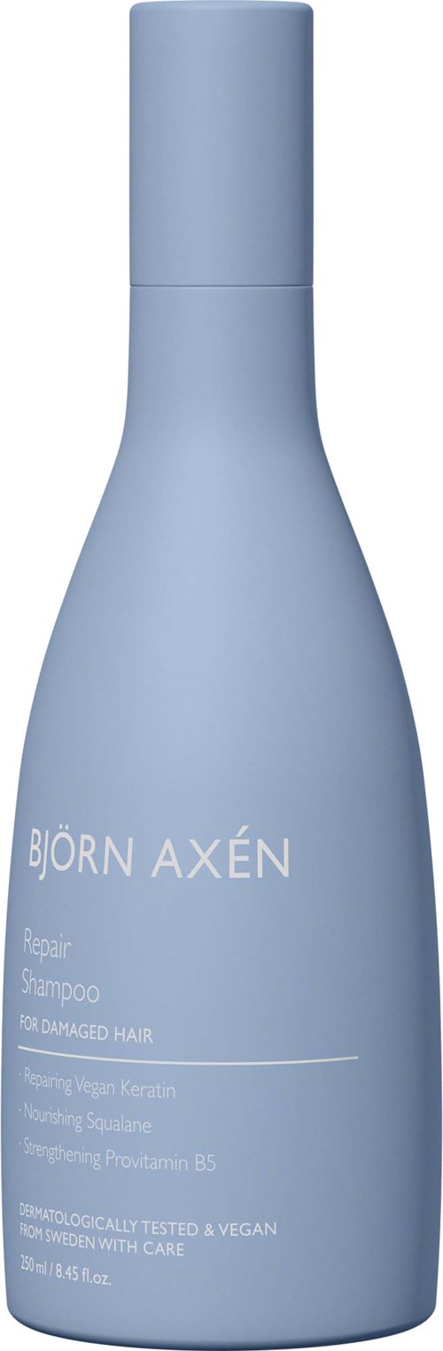 Lichtblauwe shampoo fles met witte tekst voor beschadigd haar, bevat keratine en aloë vera.