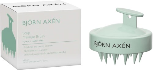 Een hoofdhuidmassageborstel van Björn Axén met een doos met een groene lama en productinformatie.