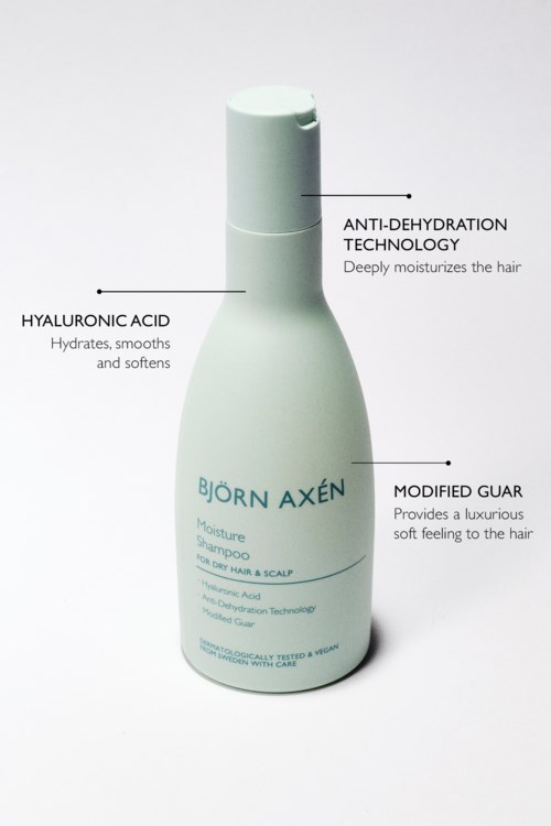 Eine weiße Shampoo-Flasche mit Text, der Inhaltsstoffe und Vorteile beschreibt, einschließlich Anti-Dehydration-Technologie und Hyaluronsäure.
