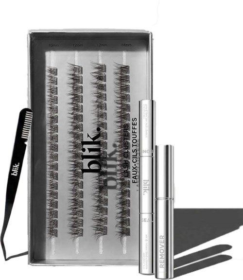 Een set make-upkwasten en wimperkrullers in een doos met gemarkeerde maten en een removerstift.