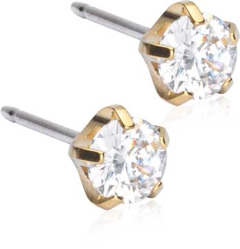 A pair of stud earrings with clear stones and gold settings, silver posts. Simple and elegant jewelry.