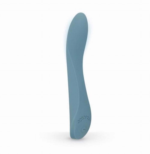 A blue, curved object stands upright with a wave-like design and a small laurel leaf symbol at the bottom.