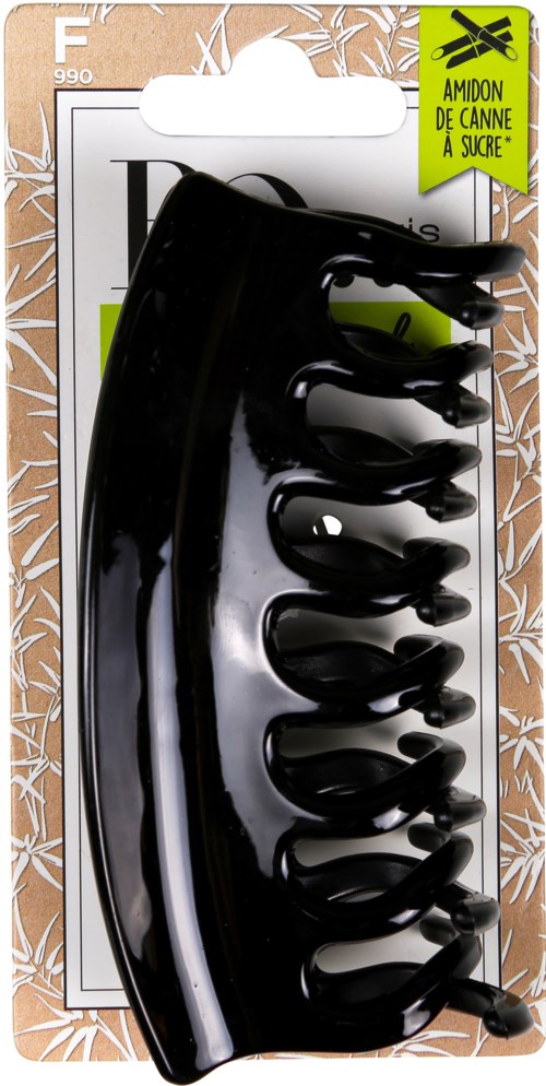 A black plastic hair clip in packaging with green and white labels, designed to hold hair in place.