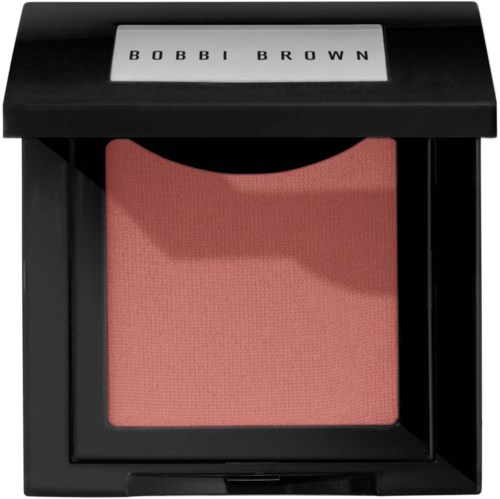 A pink blush in a black compact case with a clear lid displaying 'BOBBI BROWN' text.
