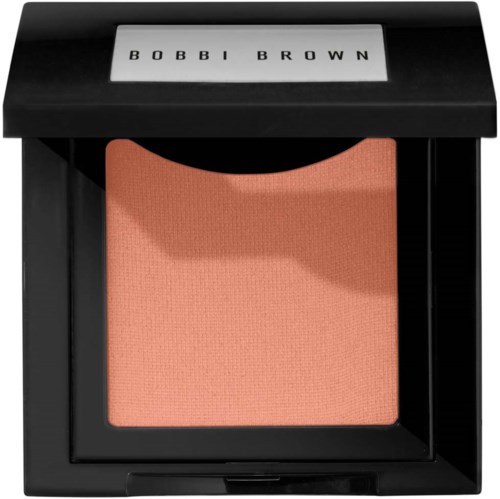 A pinkish peach blush in a black compact with the brand name 'BOBBI BROWN' on the lid.