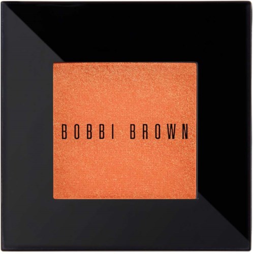 A black square makeup compact with a peach-colored blush and black text saying "BOBBI BROWN".