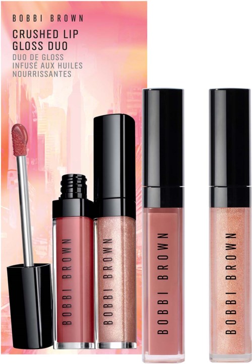Set of three Bobbi Brown lip glosses in pinks with black caps and an illustrated background.