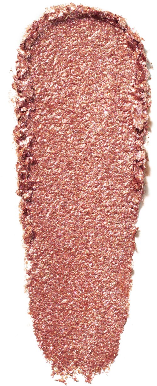 A close-up of a pinkish, textured substance shaped like a long, narrow strip with uneven edges.