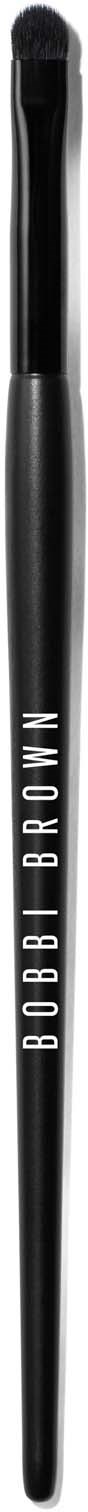 A black eyebrow brush with the brand name Bobbi Brown written on it in white.