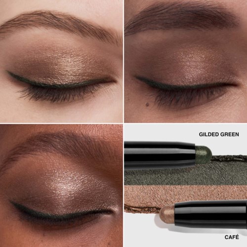 Makeup with gold and beige eyeshadow, eyeliner, and two green and beige eye pencils shown.