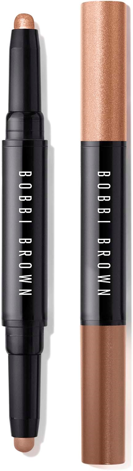 En dubbel-sidig makeup-stift med beige- och bronsnyanser för kinder eller ögon, med märket 'Bobbi Brown' på svart ytterhölje.